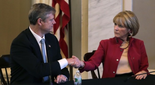 Mass. Republican nominee for governor Charlie Baker, left, shakes hands with Democratic nominee Martha Coakley following a candidates forum (AP Photo/Charles Krupa)