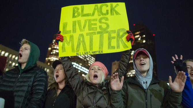 Demonstrators chant and hold signs in Boston City Hall Plaza on Dec. 4, 2014. Scott Eisen/Getty Images 